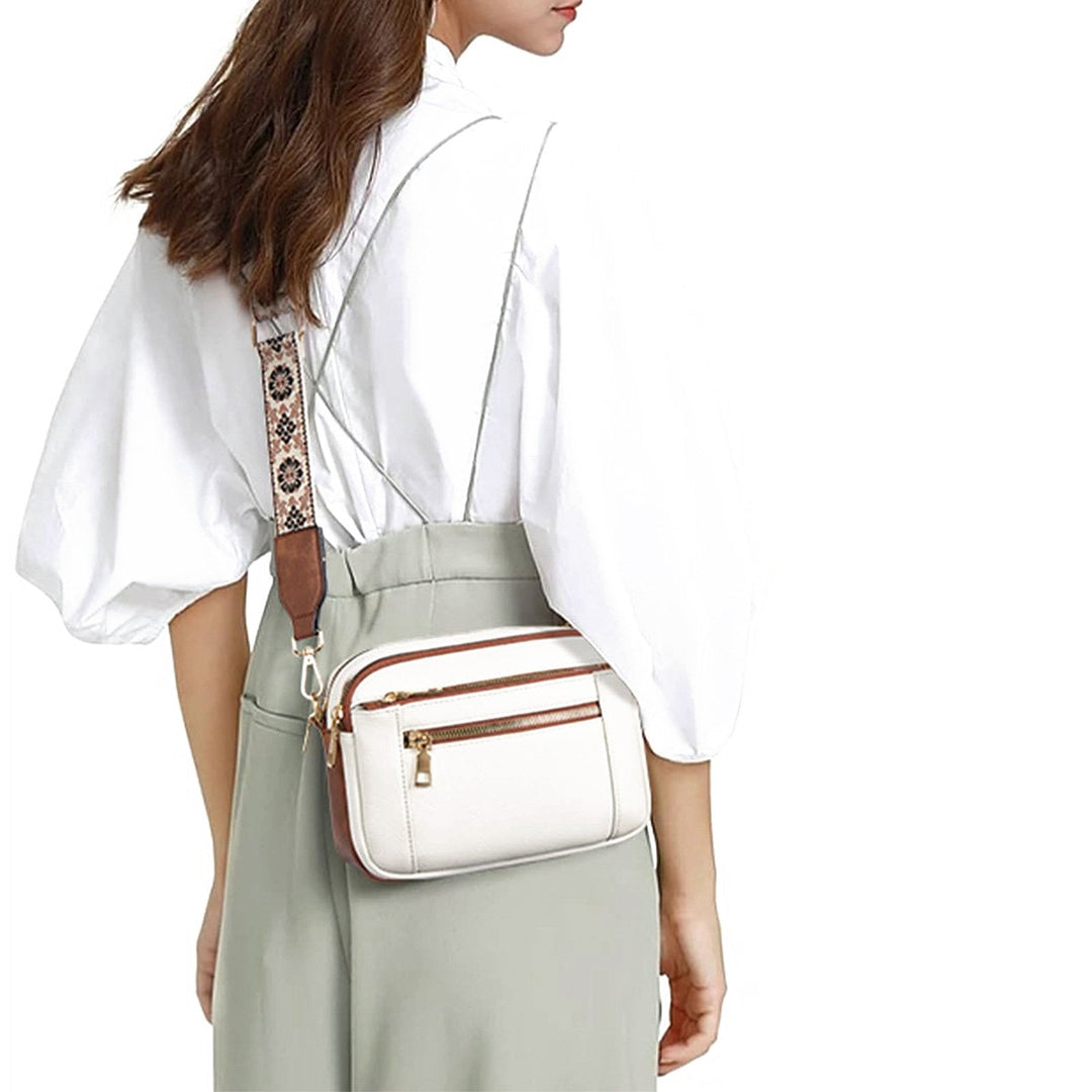 Kobiecza torebka crossbody z wieloma zamkami i nadrukowanym paskiem